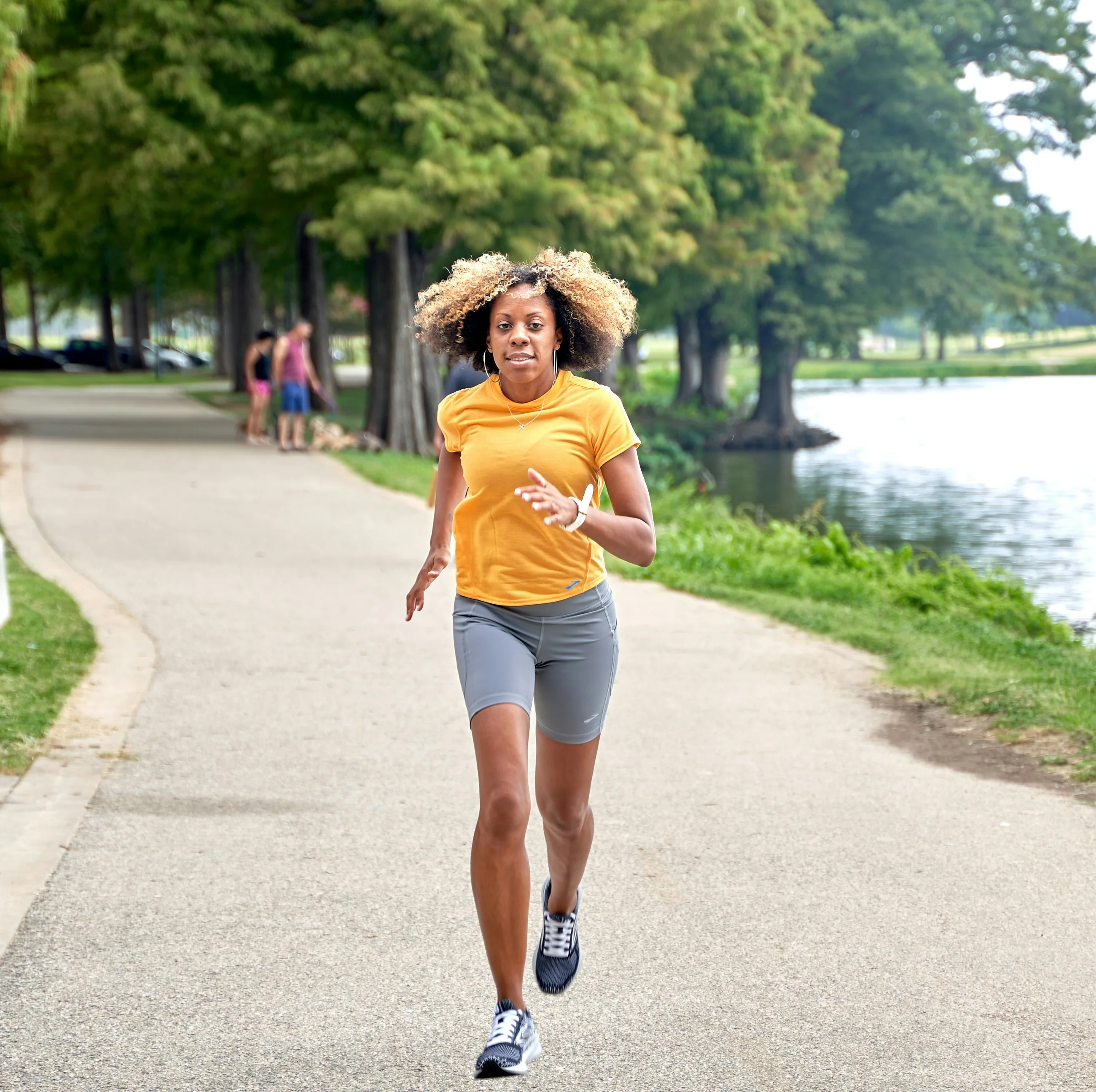 A woman enjoying a run beside a lake